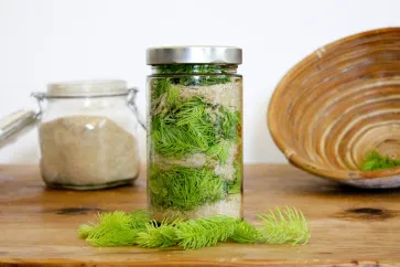 Grüner Maiwipferl-Sirup in einem Glas