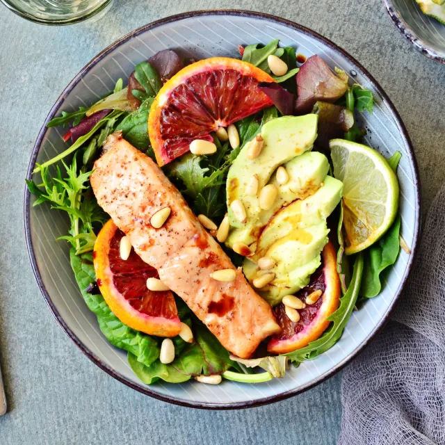 Lachs mit Avocado, Blutorangen und Sonnenblumenkernen auf Salat